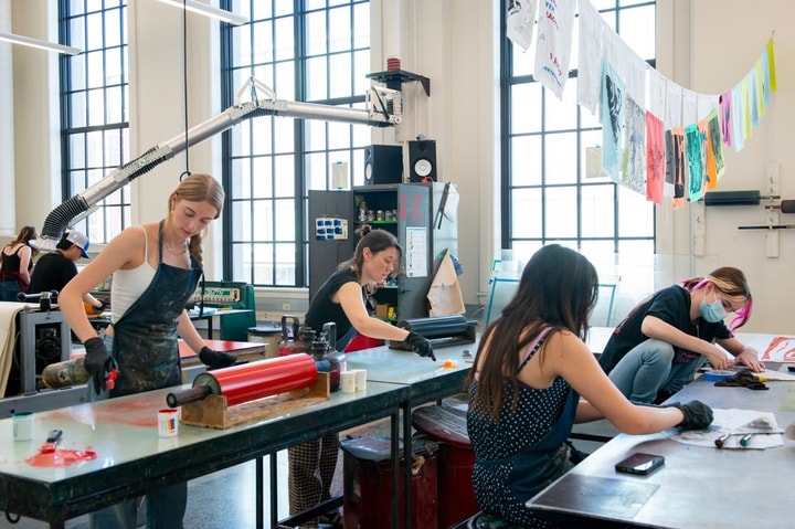 Undergraduate art students at WashU working in the printmaking studio in Bixby Hall.