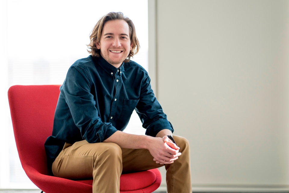 Jonathan Hanahan sitting in an armless red chair.