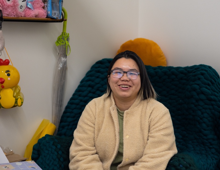 Karen Yung sitting in an armchair in her studio