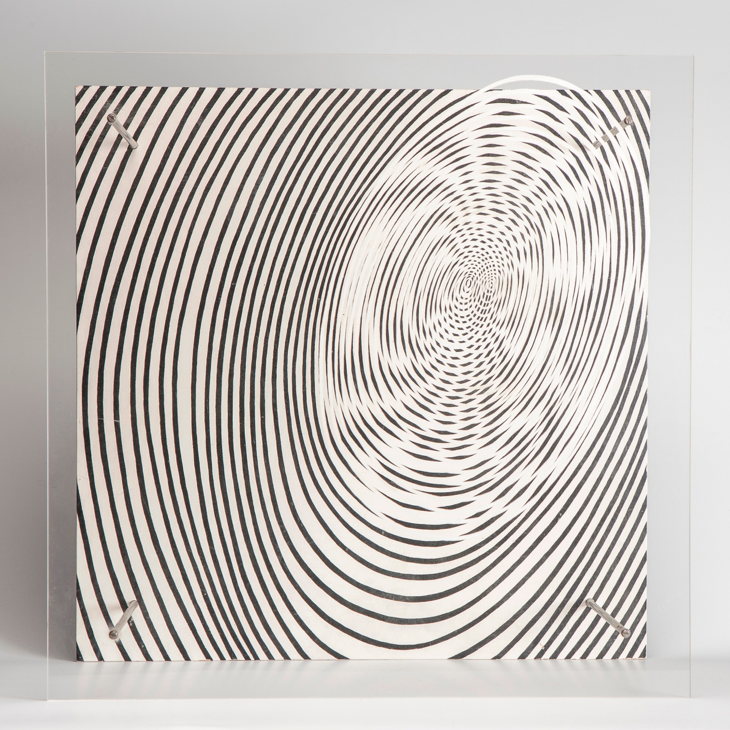 Black-and-white screen printing of a spiral on Plexiglas and painted plywood.