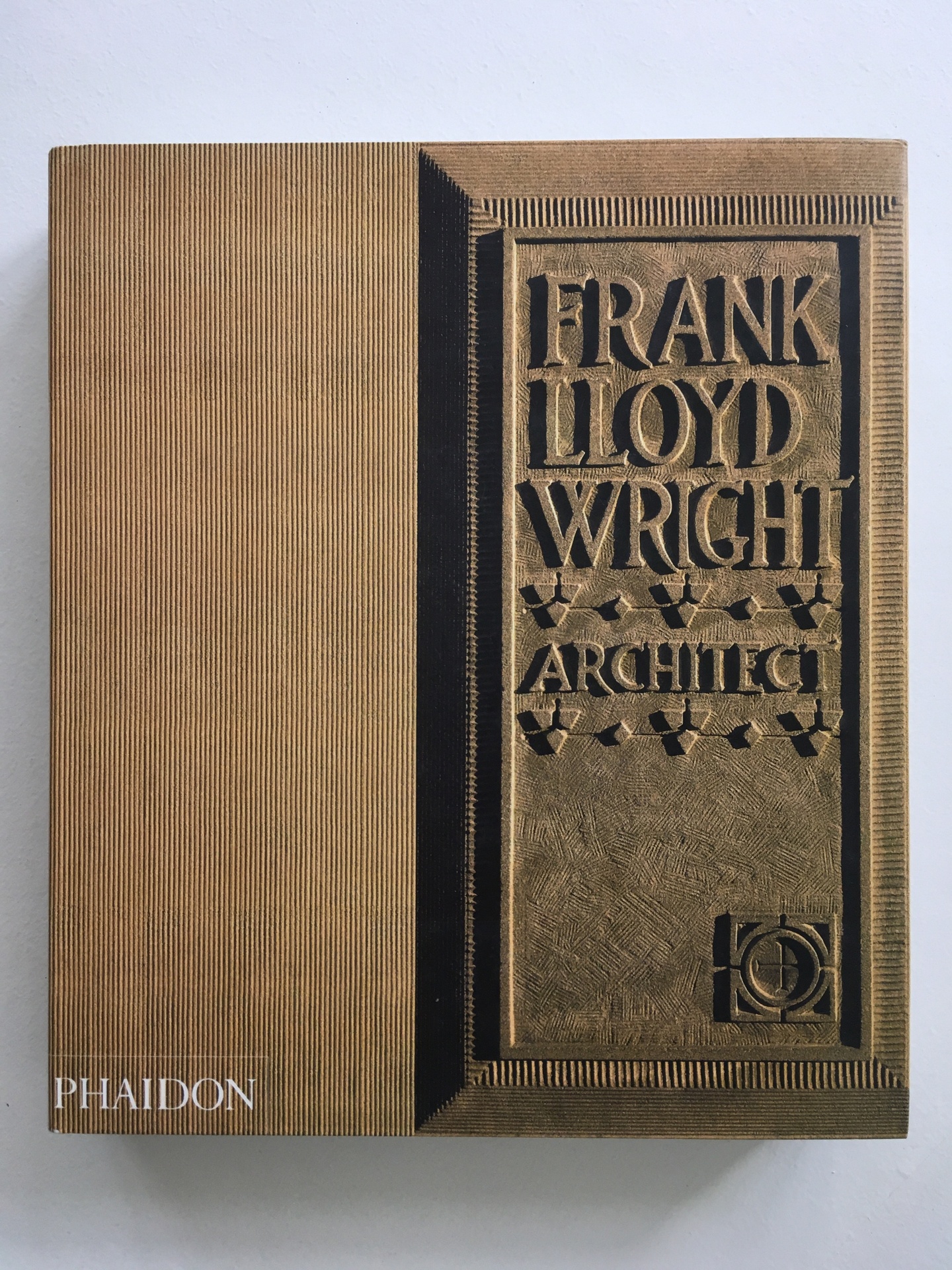 Cover of Frank Lloyd Wright, featuring a bronze cover with embossed title type.