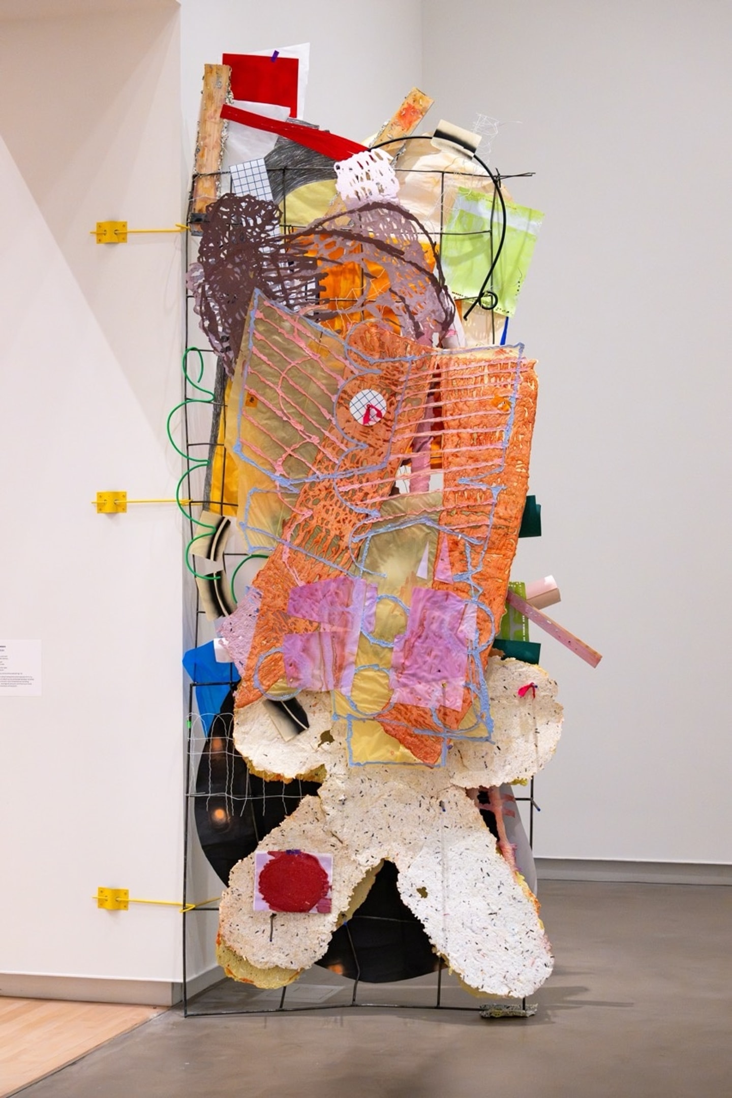 sculptural collage of mixed media such as papers and wires in many colors standing tall