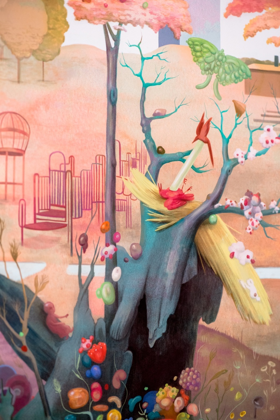 Watercolor illustration of a broken tree trunk covered in brightly colored mushrooms and bean-shaped growths. A tiny fetus appears in one corner, as well as a dead bird in a nest. In the distance is a playground.