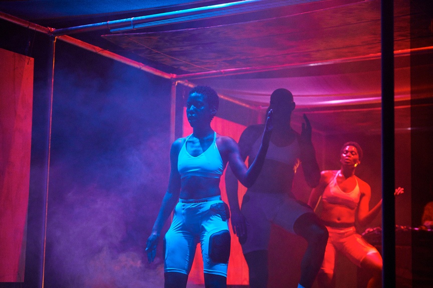 Dancers on a dramatically lit stage.