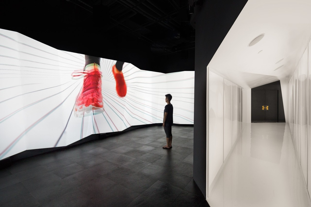 Image of a person enjoying a dynamic screen displaying a pair of running shoes, next to an image of a sleek, white hallway to a black entrance
