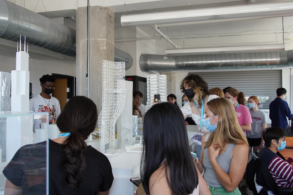 Student observing large architectural models