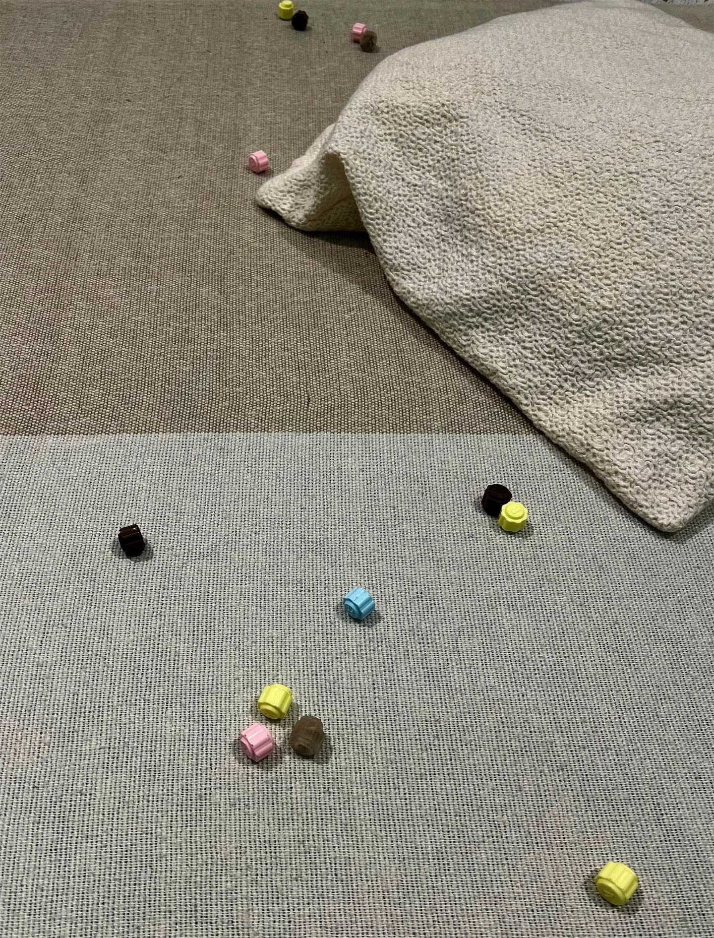 A close up of the scattered bits and the corner of the pillow