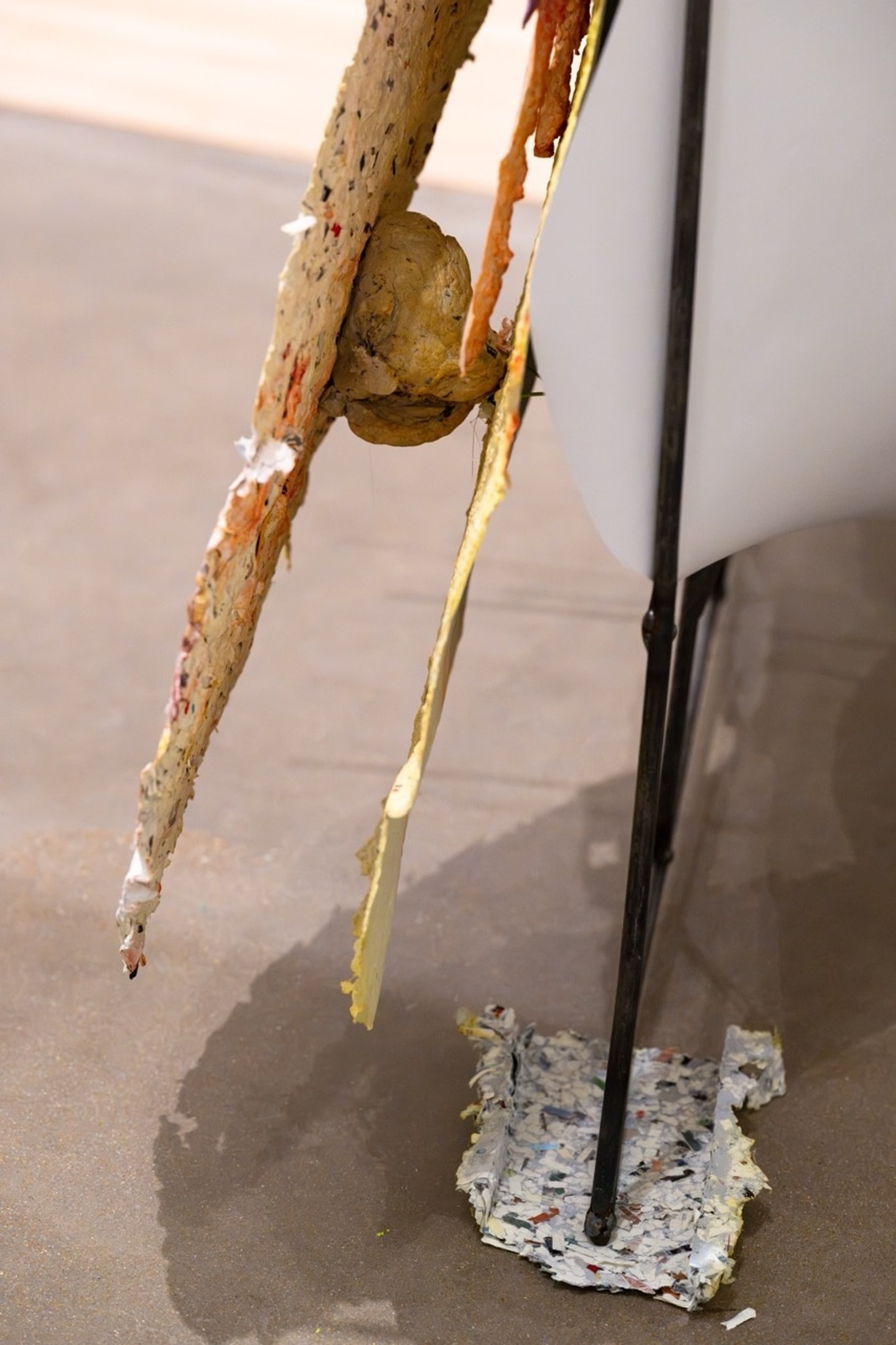detail of sculptural collage of mixed media such as papers and wires in many colors 
