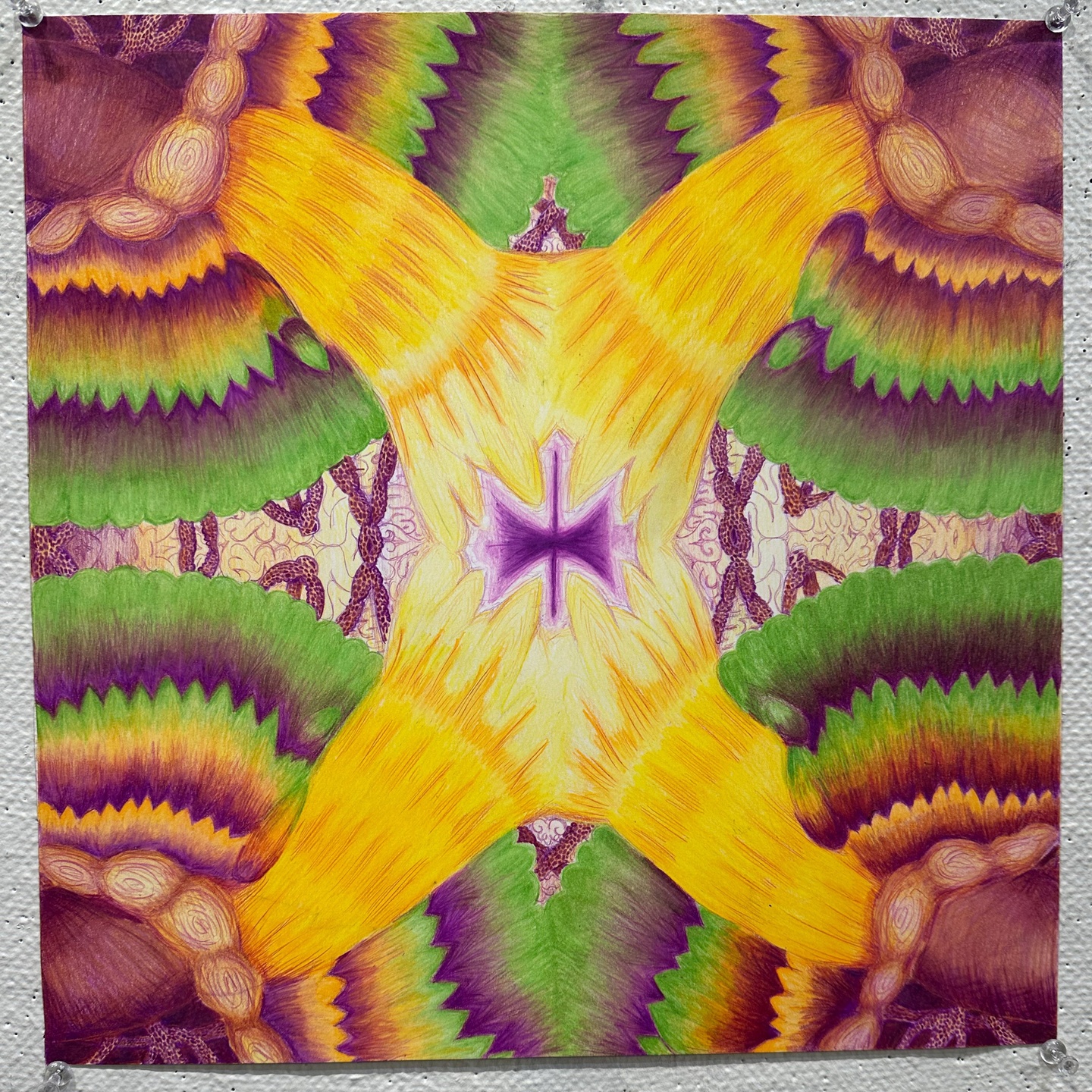 abstract image in yellows, greens and reds resembling the inside of a kaleidoscope