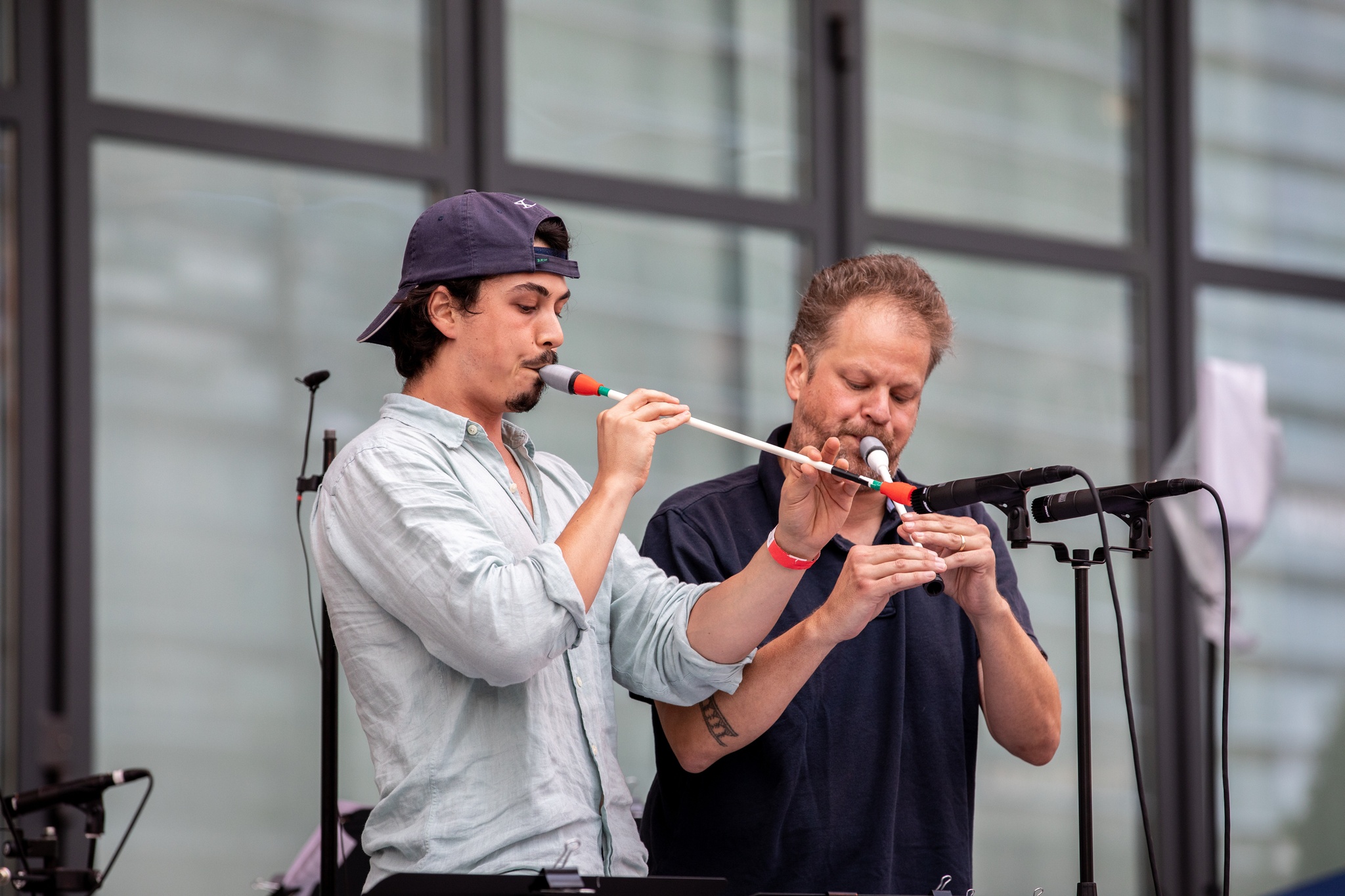 Men playing live instruments on a stage.