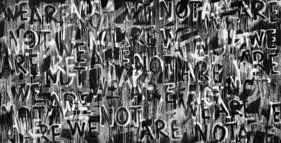 A black-and-white composition featuring the words WE ARE NOT throughout