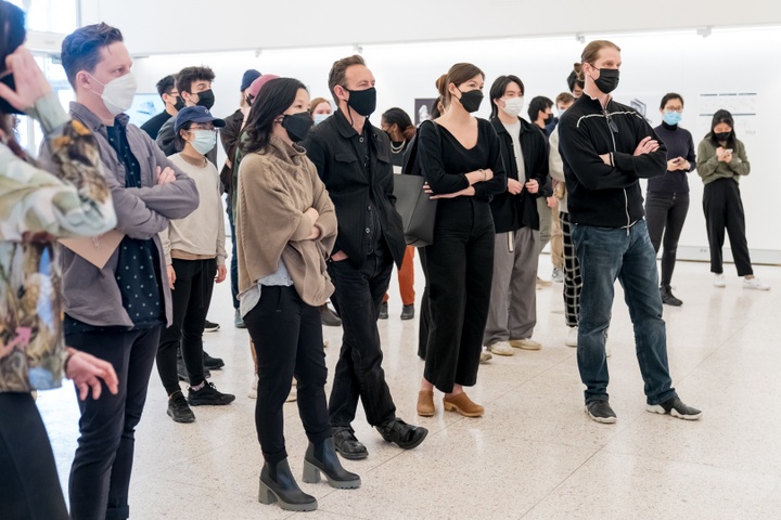 Large group of people in a well-lit gallery space.