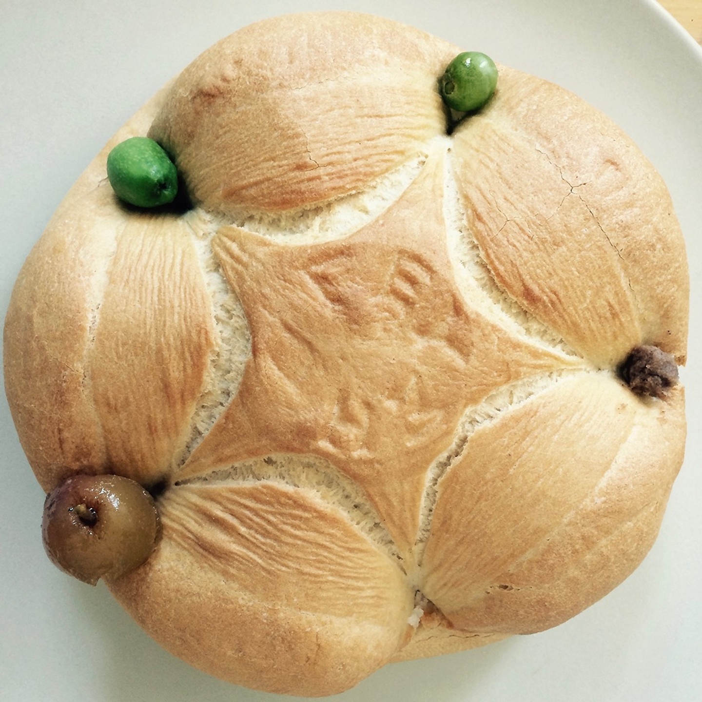 image of a round loaf of bread with a star imprint in the middle 