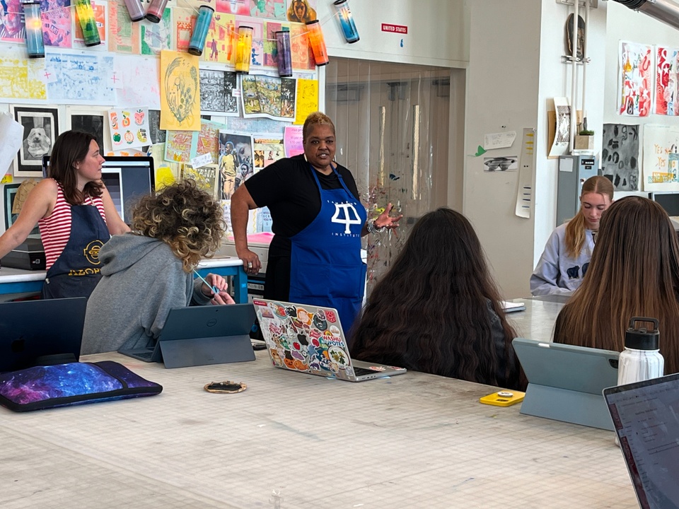 Artist talking to students in printmaking class