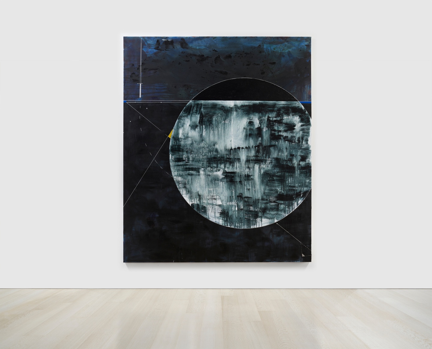 An abstract painting in dark blues and grays with geometric shapes in outline and a large circle in layered, dripping paint