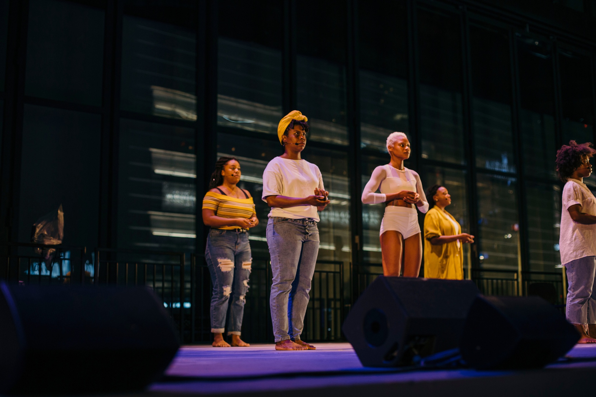 Women acting on stage barefoot.