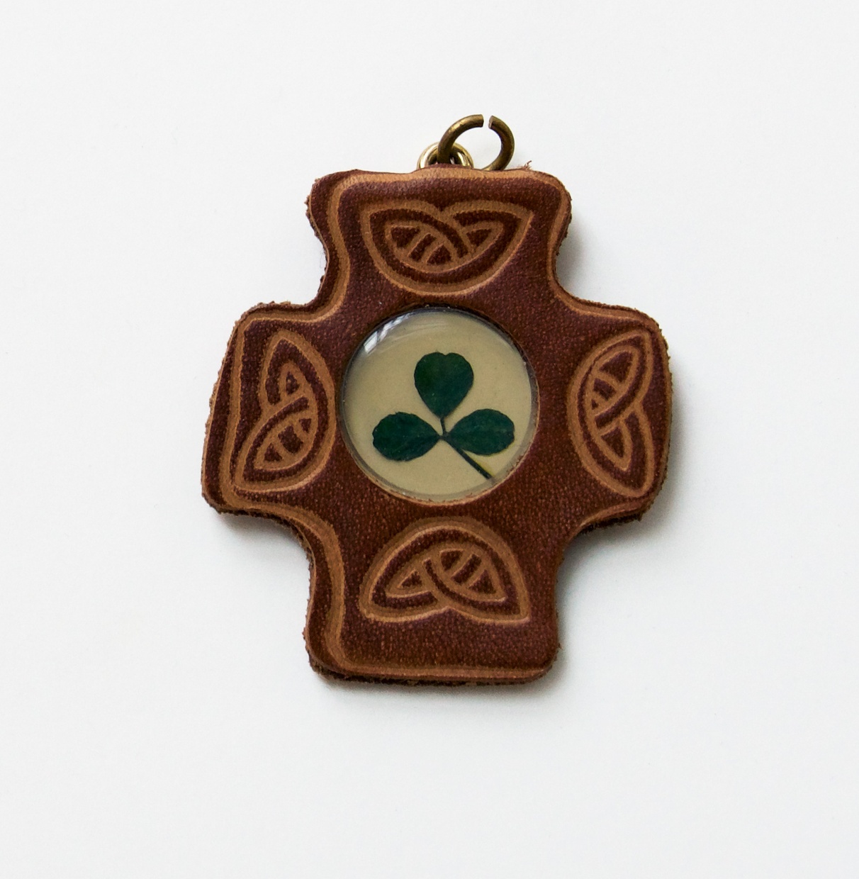 A decorative cross with a clover encased in the center