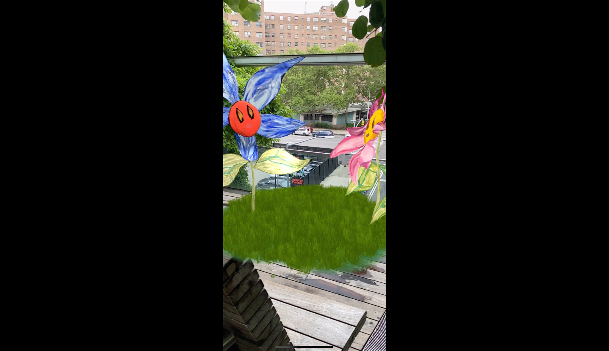 Two tall AR flowers with cartoonlike faces standing in a patch of green grass on the High Line