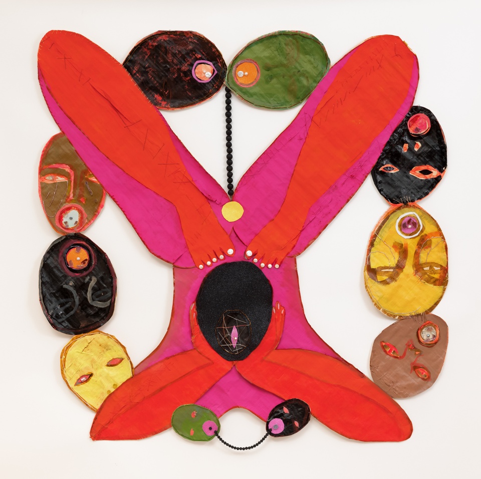 Mixed media painting featuring a vibrant, rounded pink and orange X-like figure in the center, with ovular shapes—some appearing to be heads, around the perimeter in black, olive green, yellow, and brown. Composed of ink, acrylic, freshwater pearls, lava beads, fire glass, glitter, abalone, thread, and glass beads on papyrus.