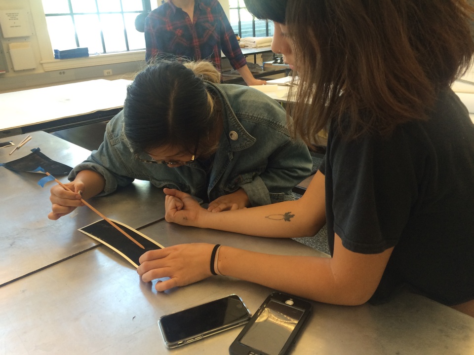 Students drawing each others' heartbeats.