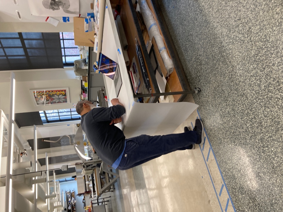 artist drawing on table in print shop