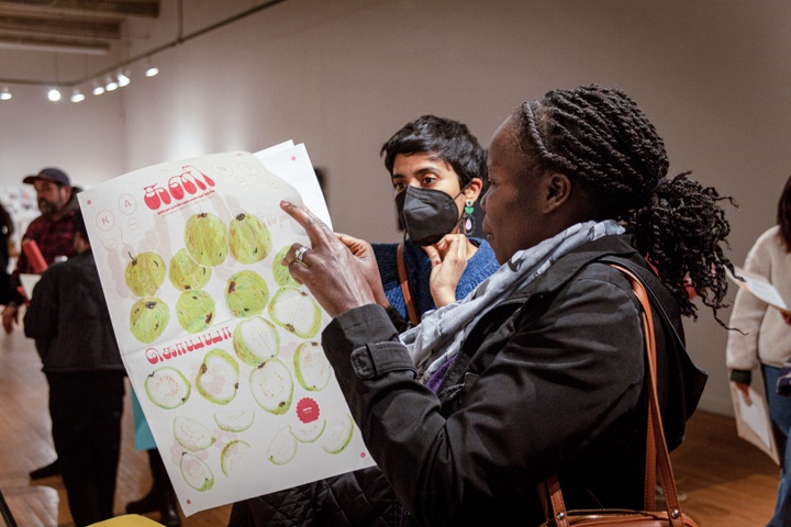 A visitor flips through a large zine 