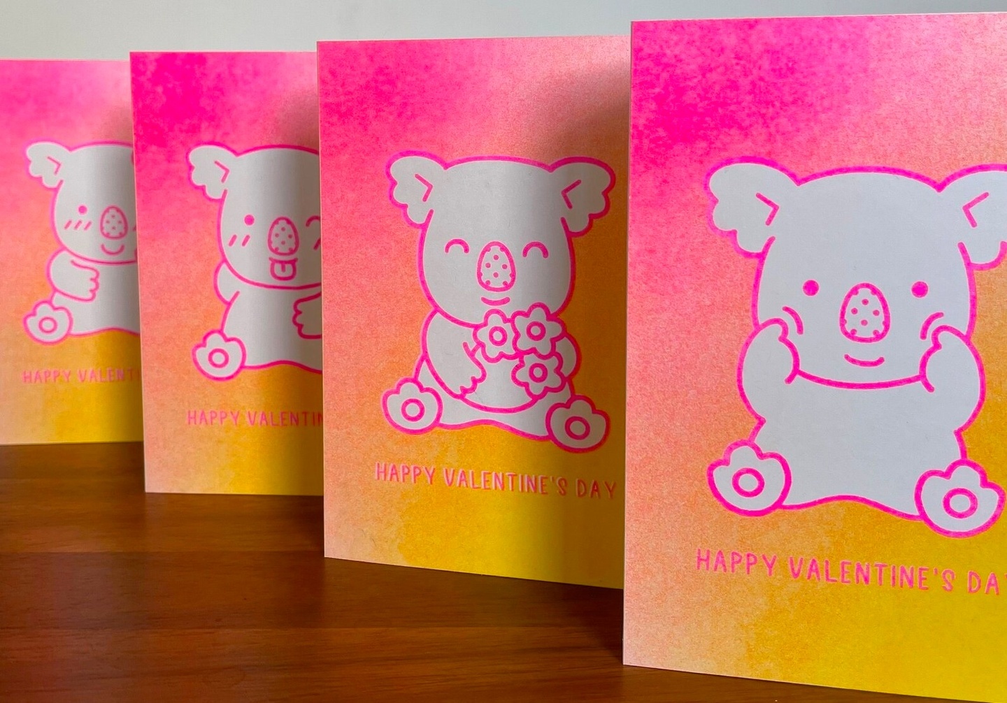 4 valentine cards lined up with white koala bear with pink and yellow background