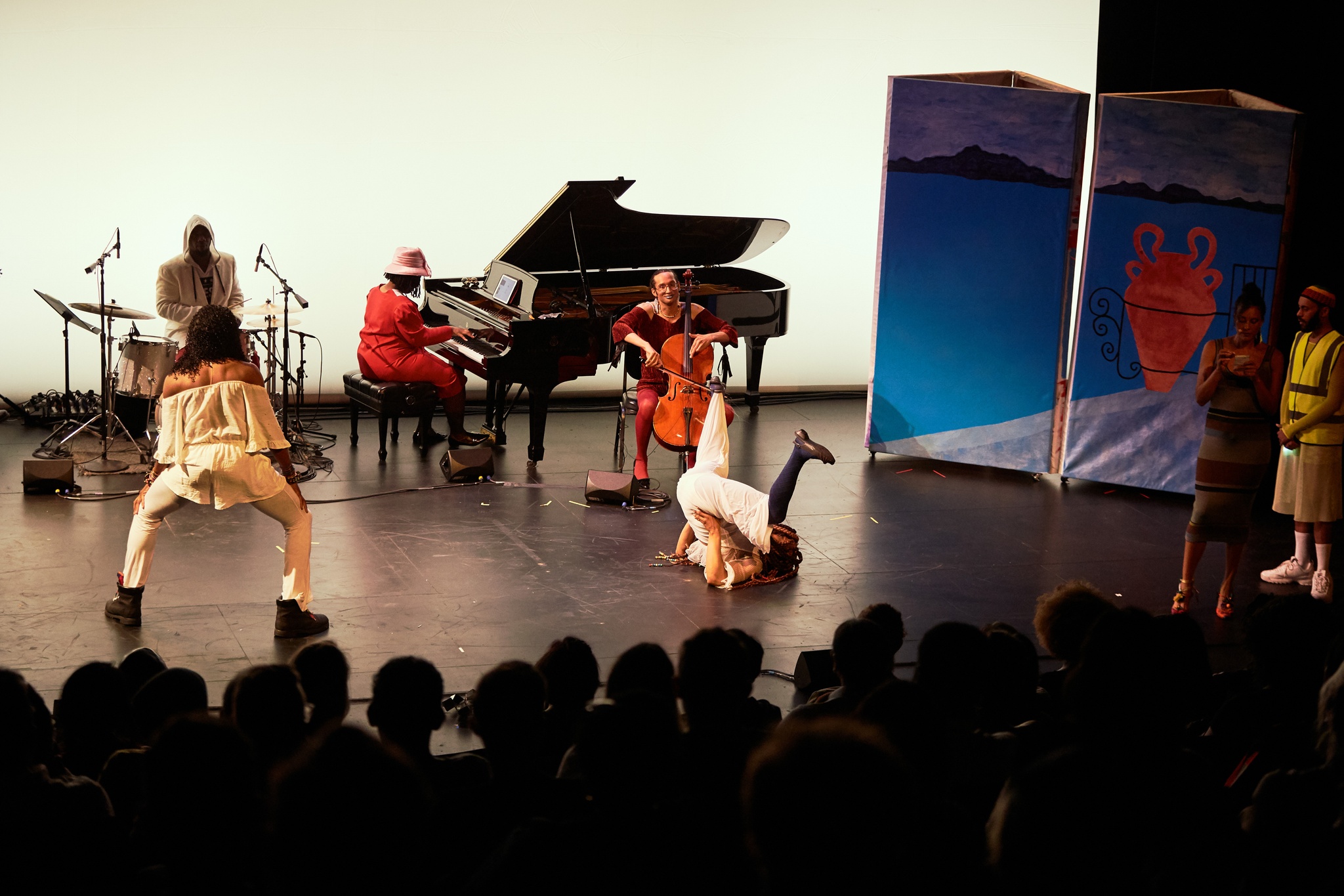 Dancers and musicians performing together on a stage.