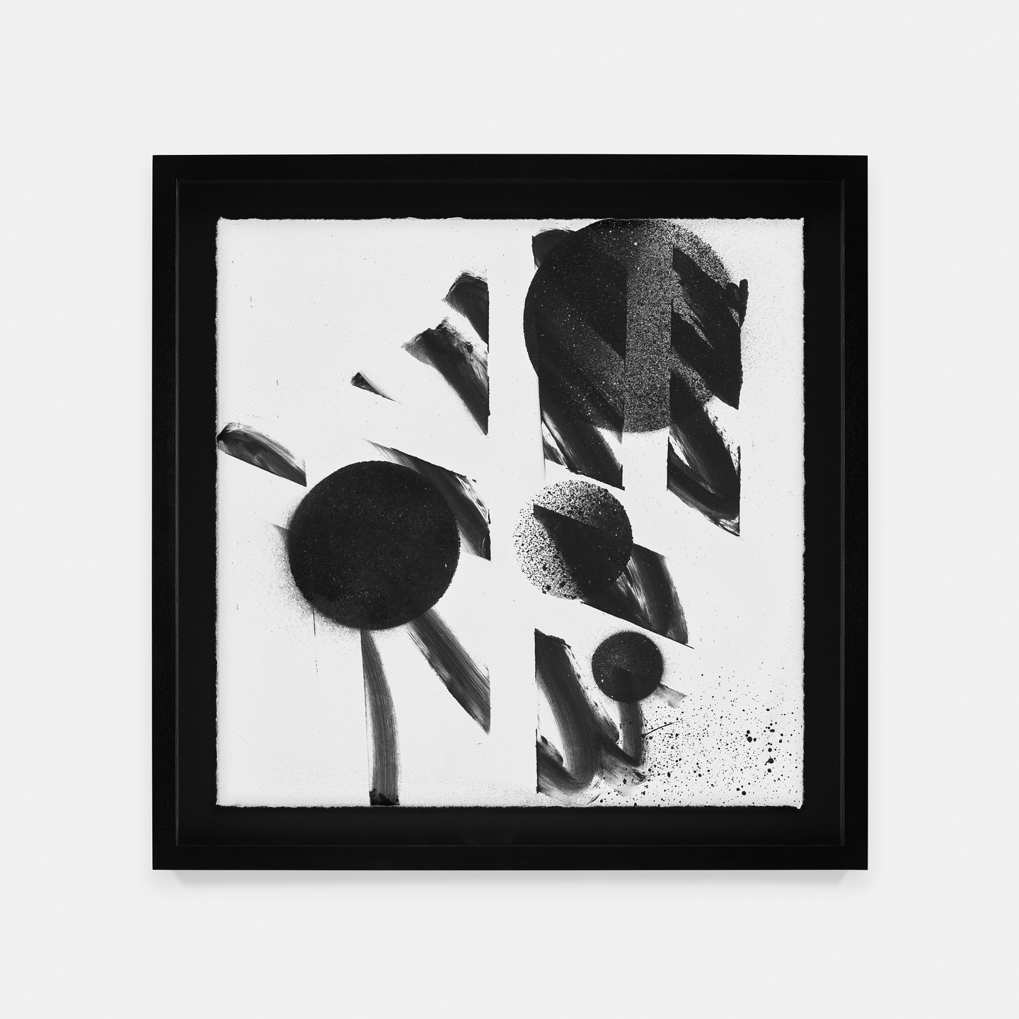 A black-and-white abstract composition featuring spray-painted circles seemingly under a grid stencil