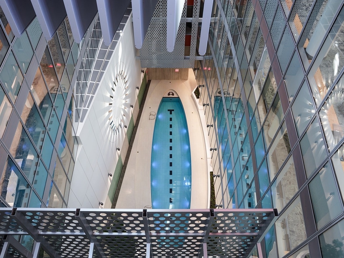 Overhead photograph of room with pool and circular illuminated sculpture above