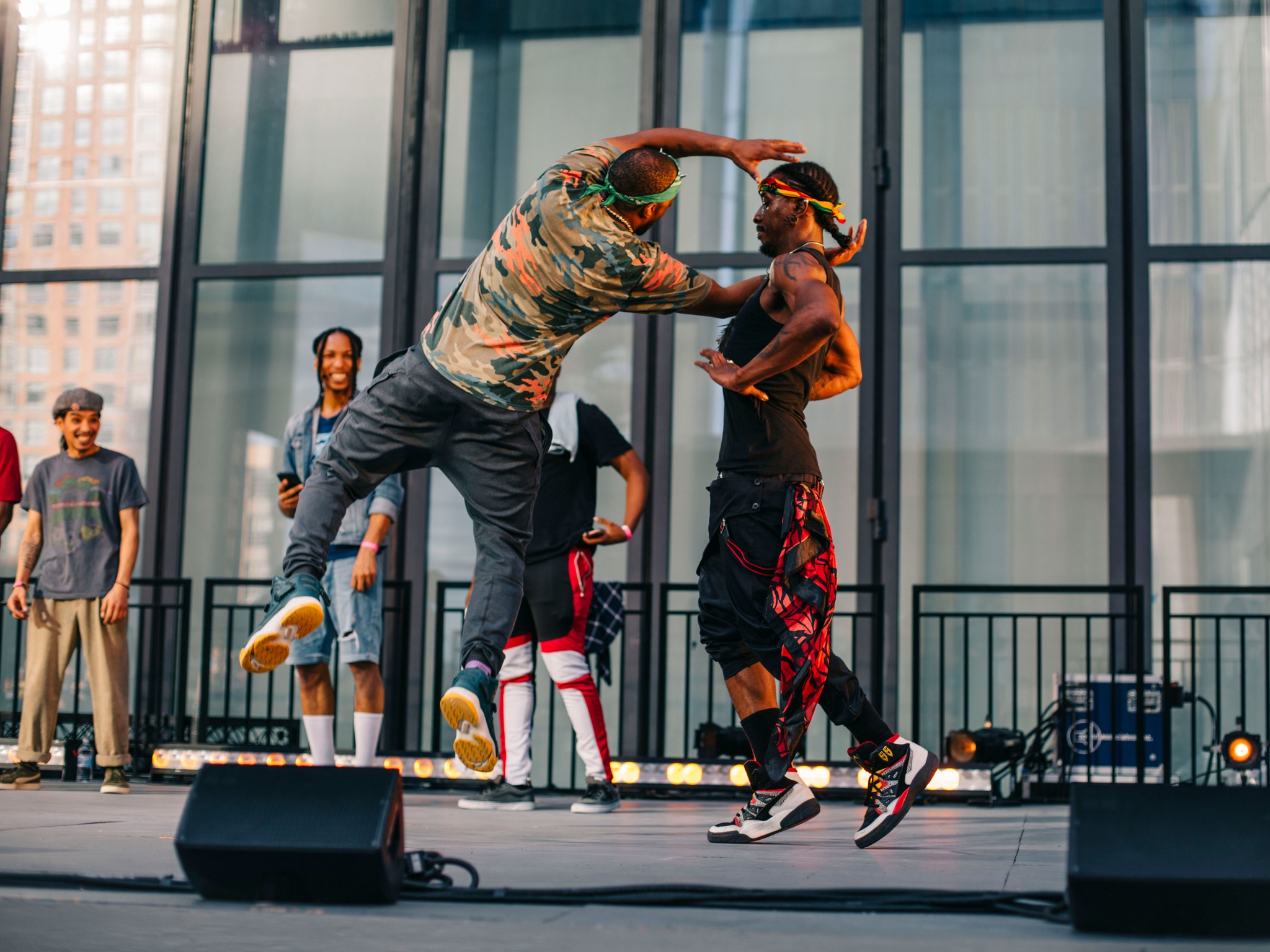 A group of dancers in motion on a stage.