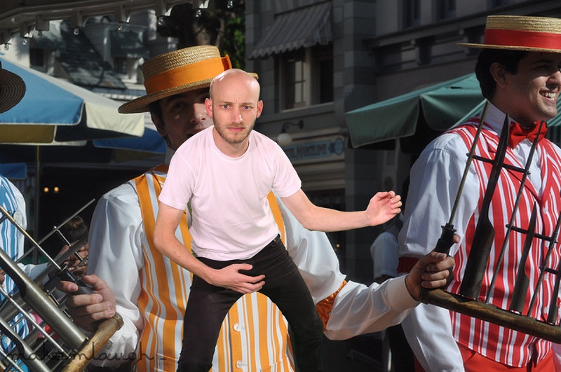 A photo from Sam Lavigne's Open Call commission Training Poses depicting Two uniformed workers performing tricks at a carnival