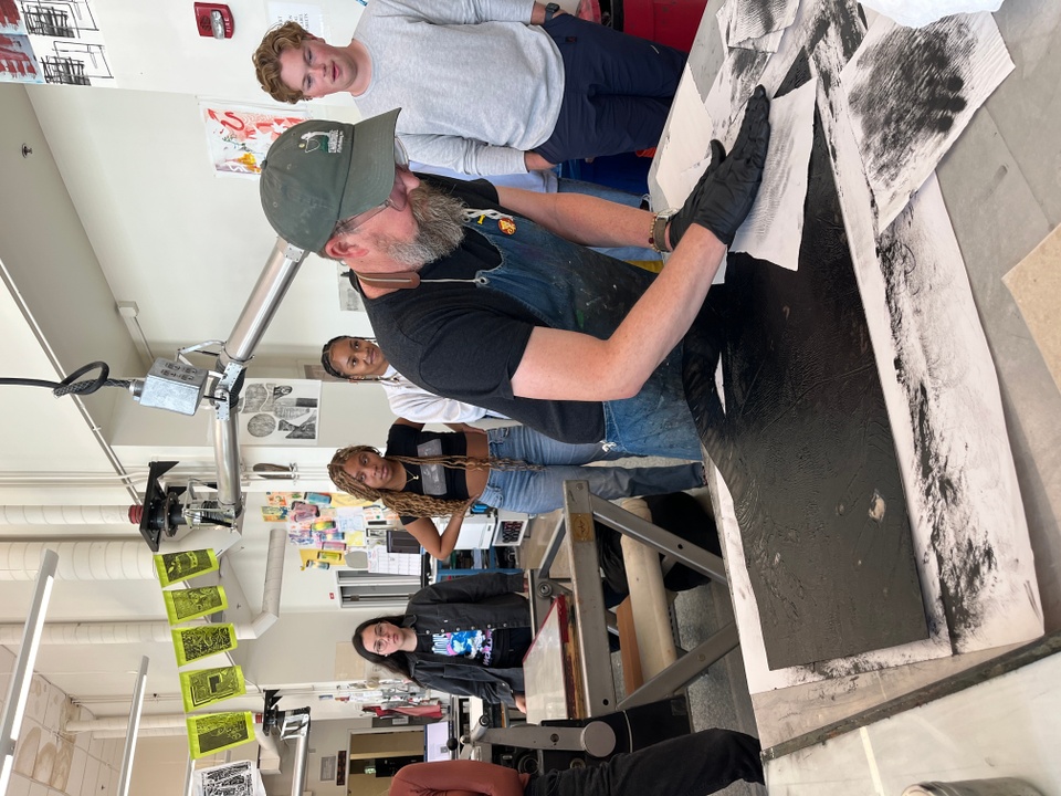 Printer Tom Reed inking a test plate