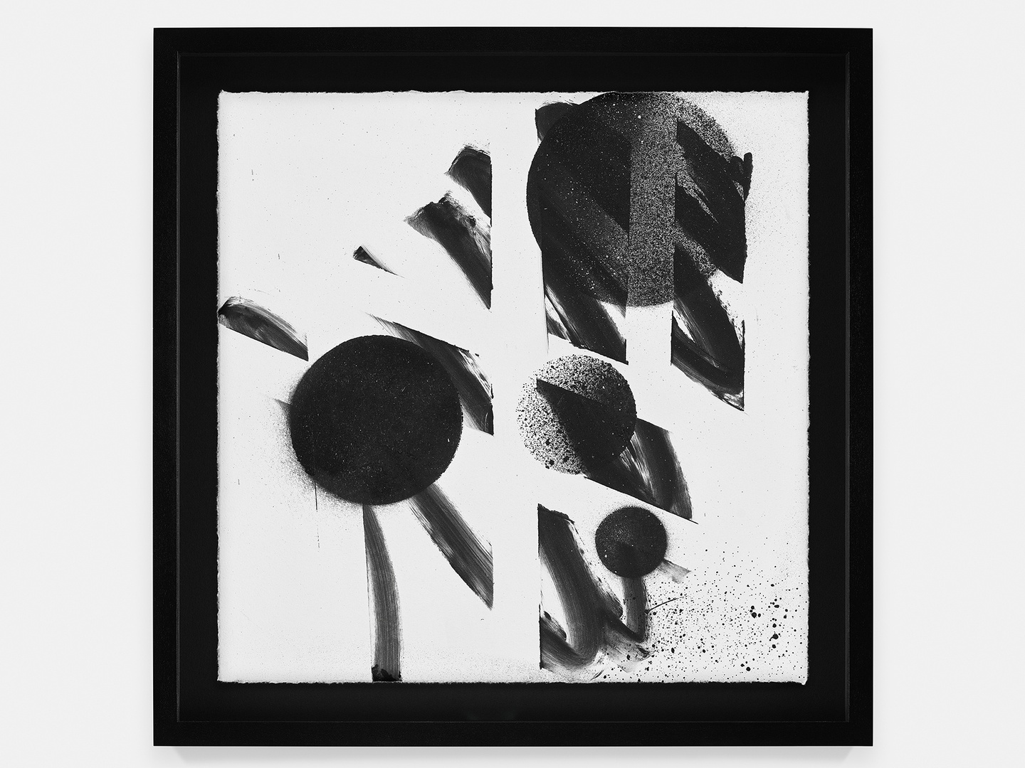 A black-and-white abstract composition featuring spray-painted circles seemingly under a grid stencil