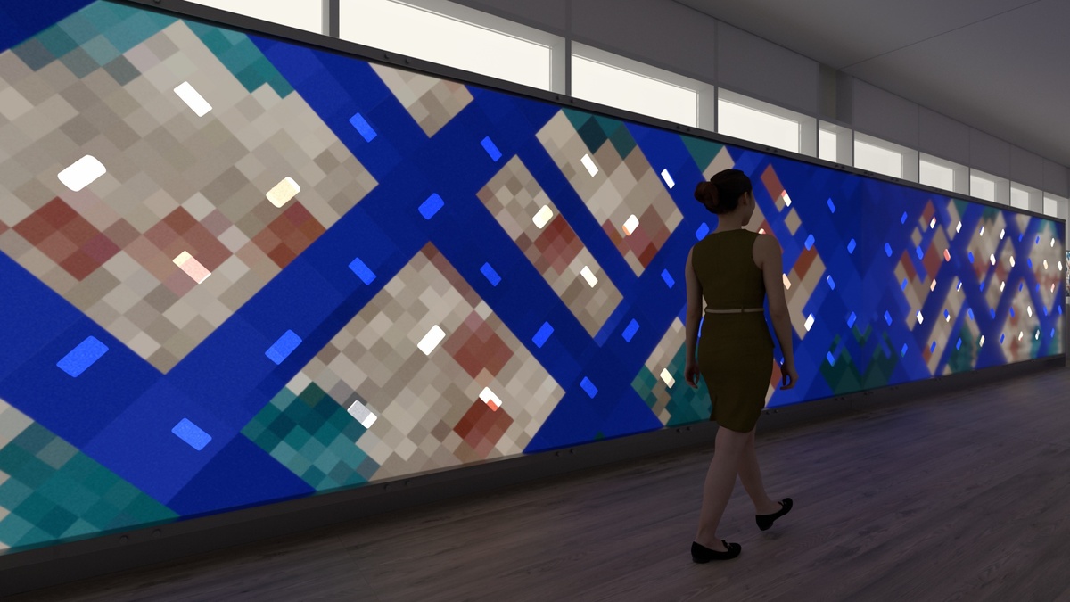 A woman walking past another illustration illuminated onto the interactive wall, composed of beige squares on a blue backdrop
