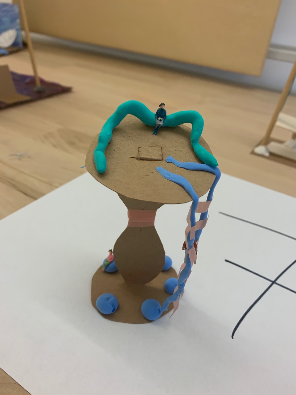 A model made out of cardboard, clay, and other materials.