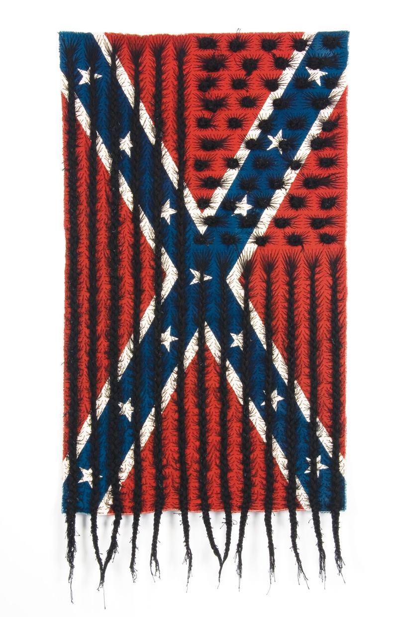 A Confederate flag with black hair woven into it in the shape of the American flag.