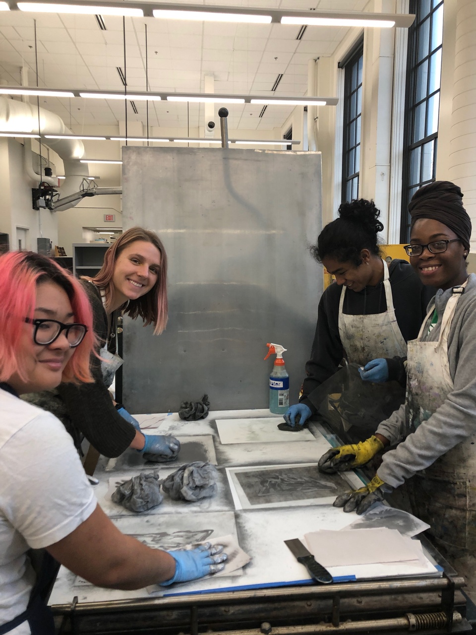 Students working on artist project at the press