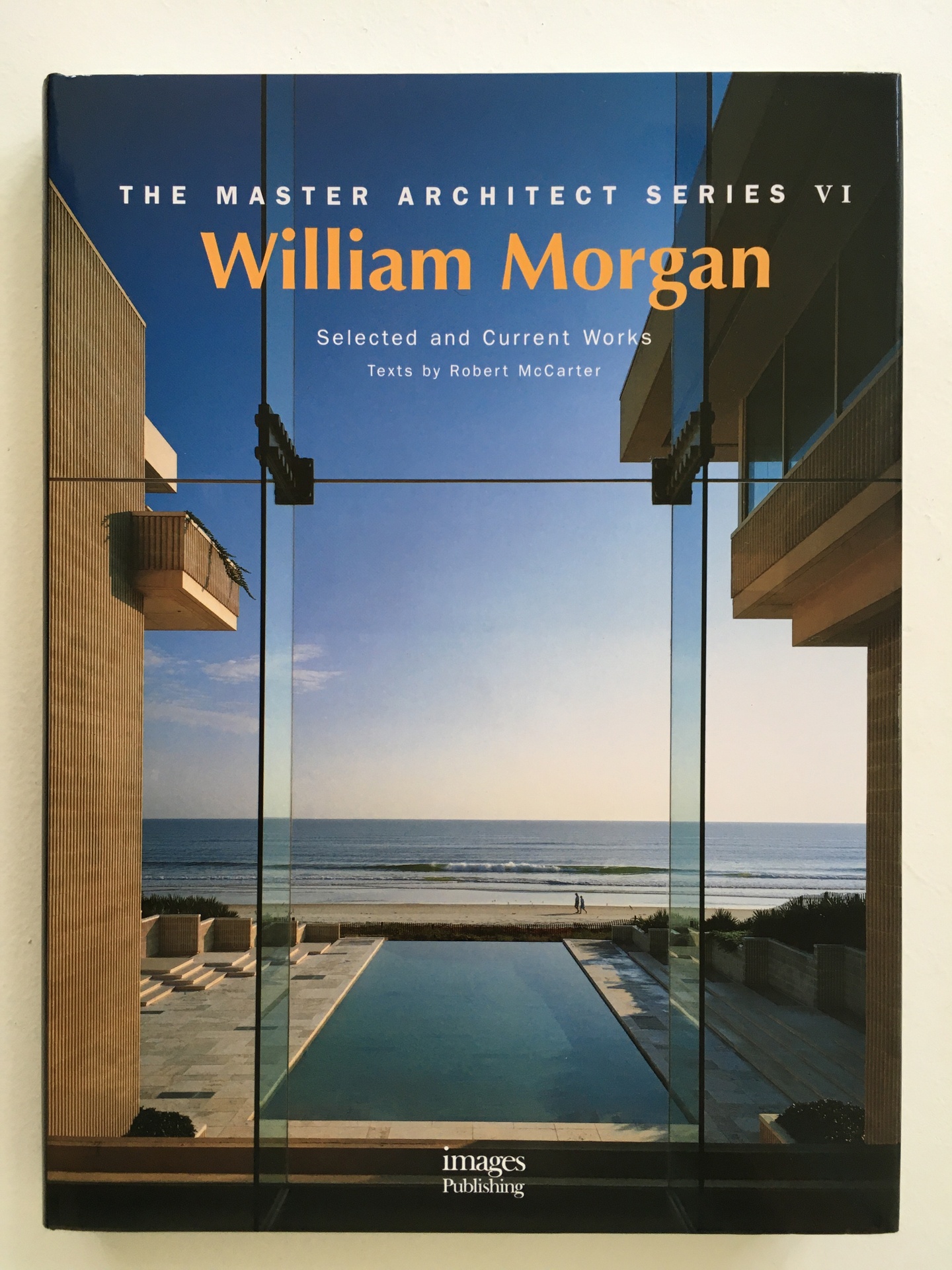 Cover of William Morgan, featuring a photo looking out of a building past an infinity pool to the waterfront.