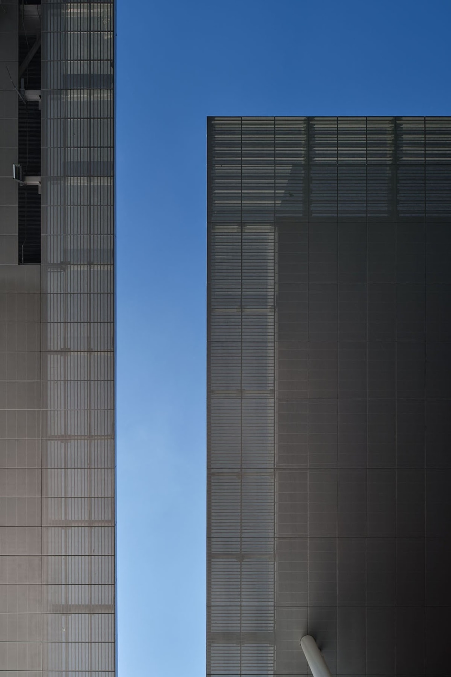 looking up at a metal canopy against a blue sky