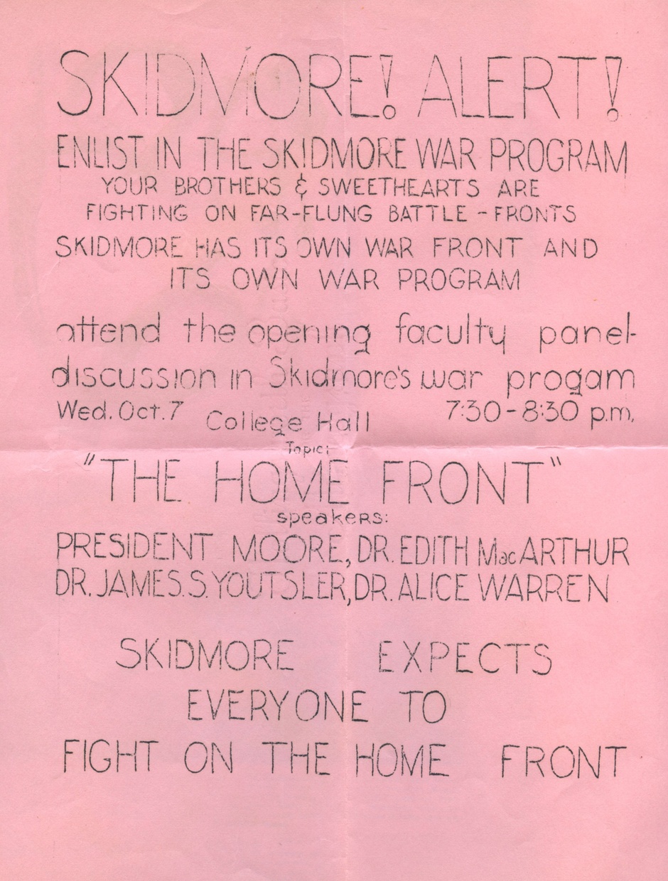 A pink document with crease marks in the center has the text “SKIDMORE! ALERT” in large, light, thin font.