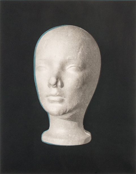 image of white mannequin head on black background
