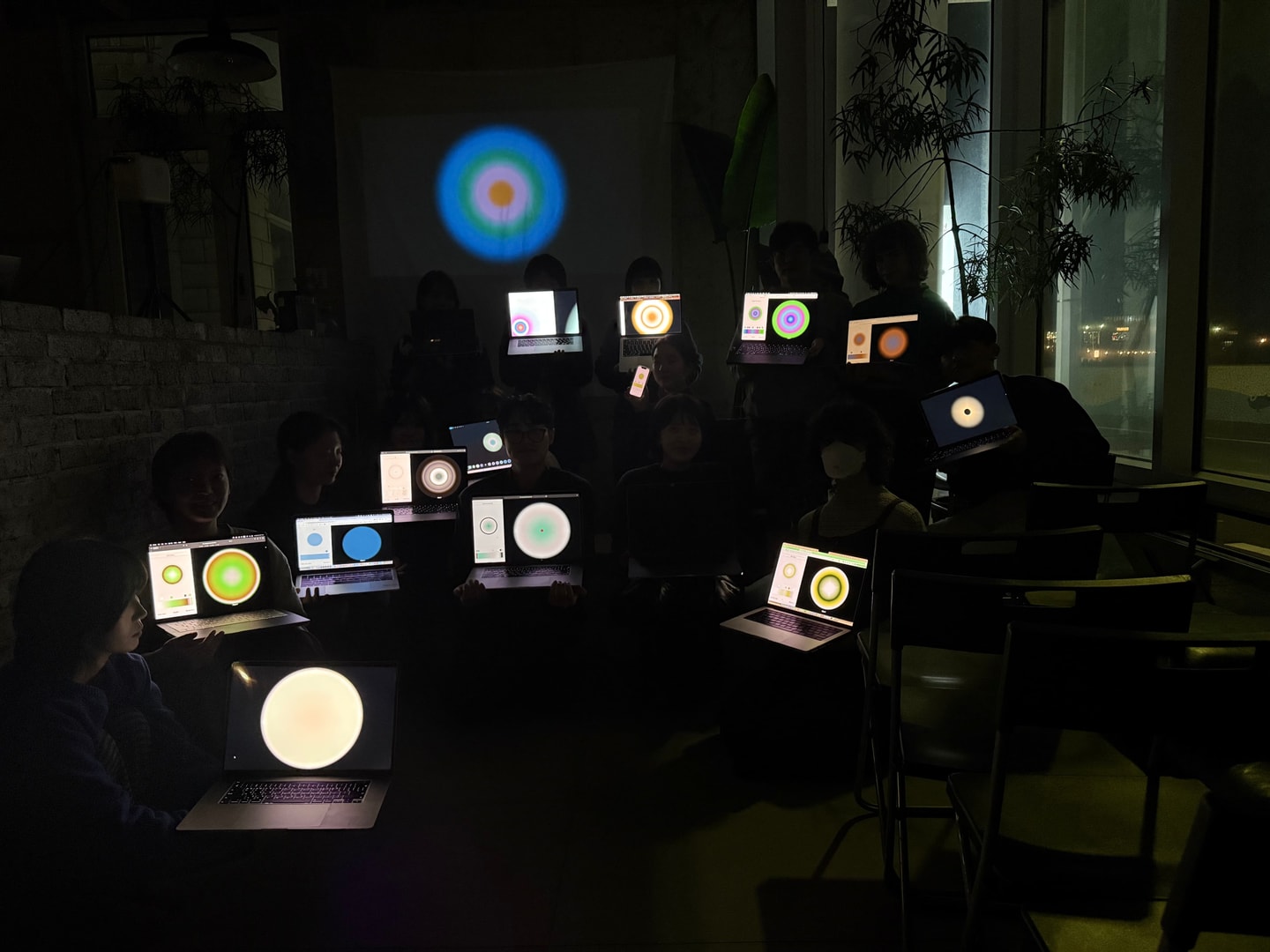 people holding up computers with spheres