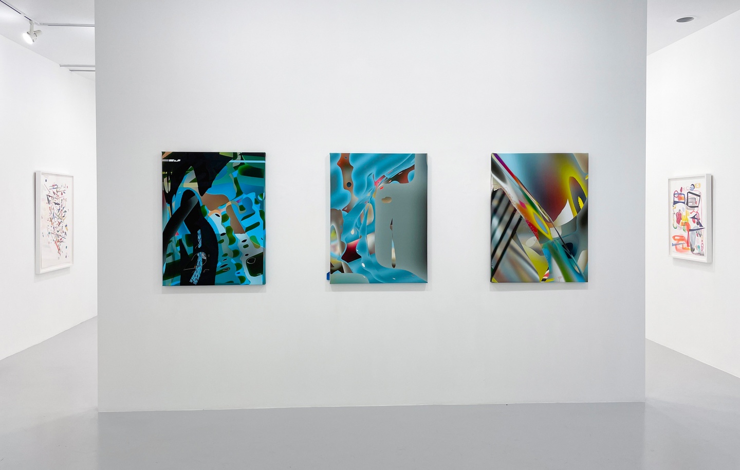 Photo of art installation of 3 vertical artworks with layers of color
