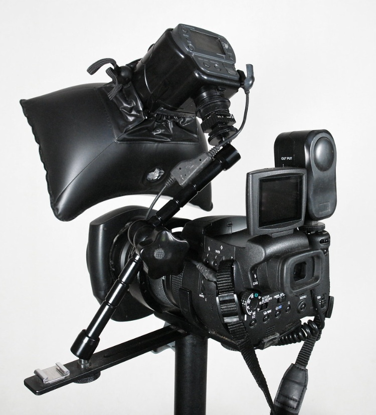 A camera on tripod with attached light