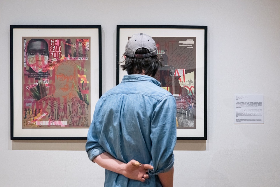 Person looks at two framed collage works in a gallery.