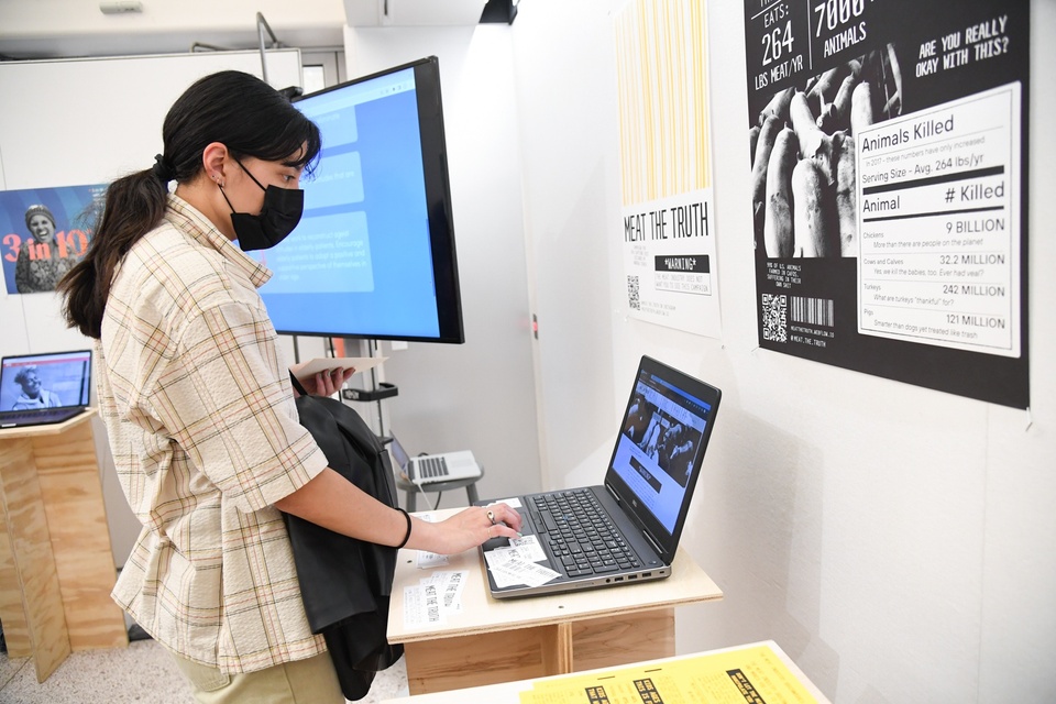 A student clicks through Andrew Storch's project on a laptop.