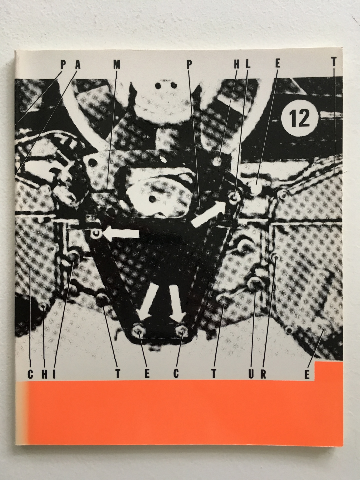 Cover of Building Machines, Pamphlet Architecture 12, featuring a black and white gear-like illustration with an orange bar at the bottom.