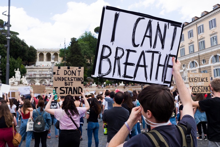 Photo of big crowd of protesters, holding signs saying things like I Can't Breathe.