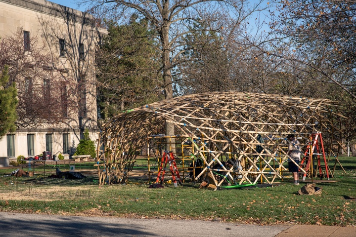 Bamboo pavilion on grass lawn.